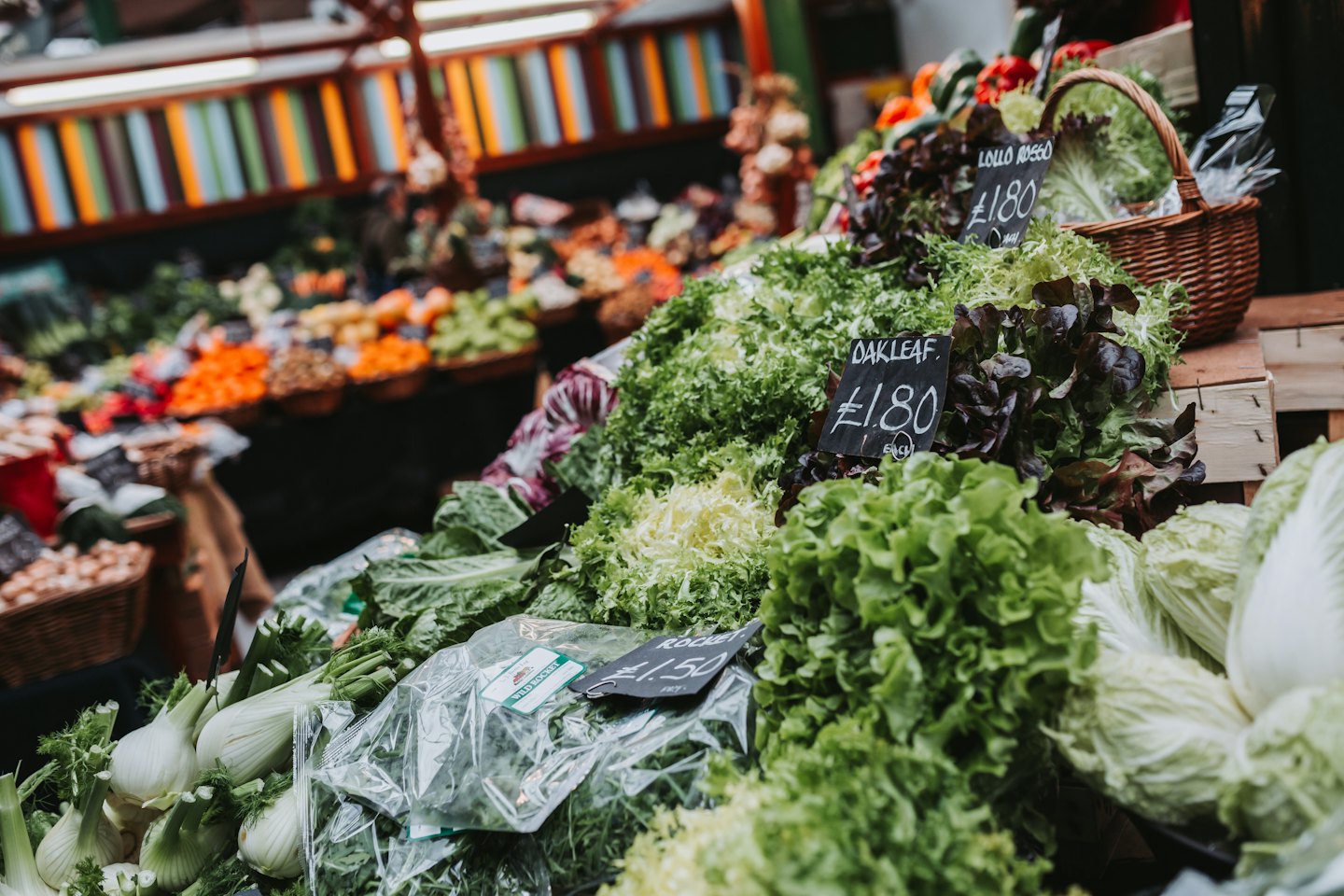 Fresh leafy green vegetables arranged at an outdoor market stall.